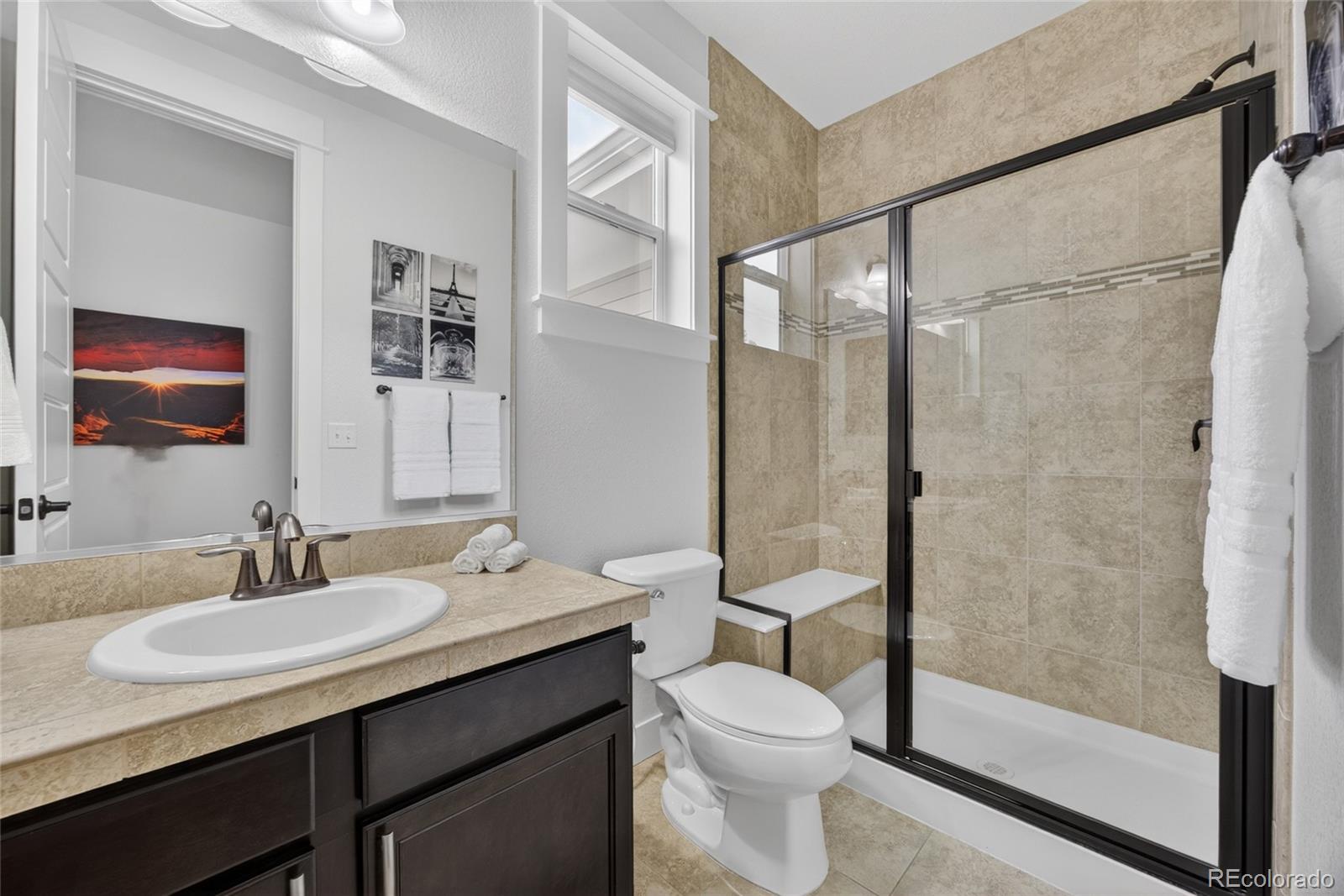 20554 East Shady Ridge Road Parker, CO 80134 - Photo 21 of 49 a bathroom with a granite countertop sink toilet and shower