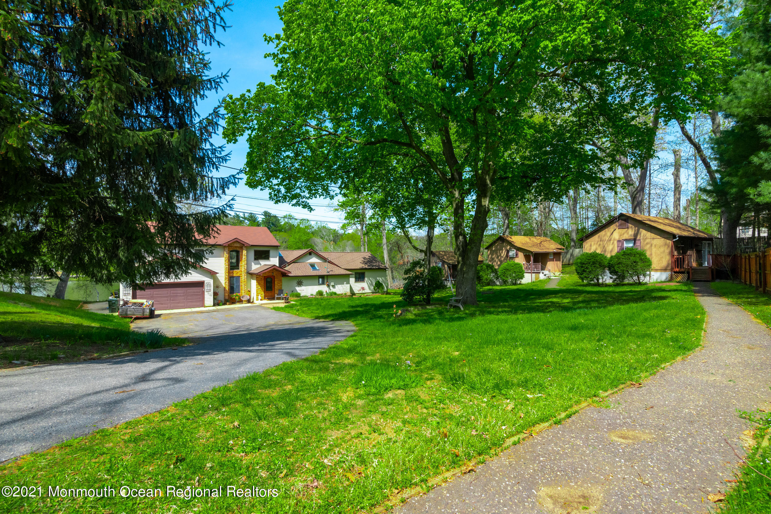 209 Pond Road Freehold, NJ 07728 - Photo 3 of 44 a view of a house with garden and a tree