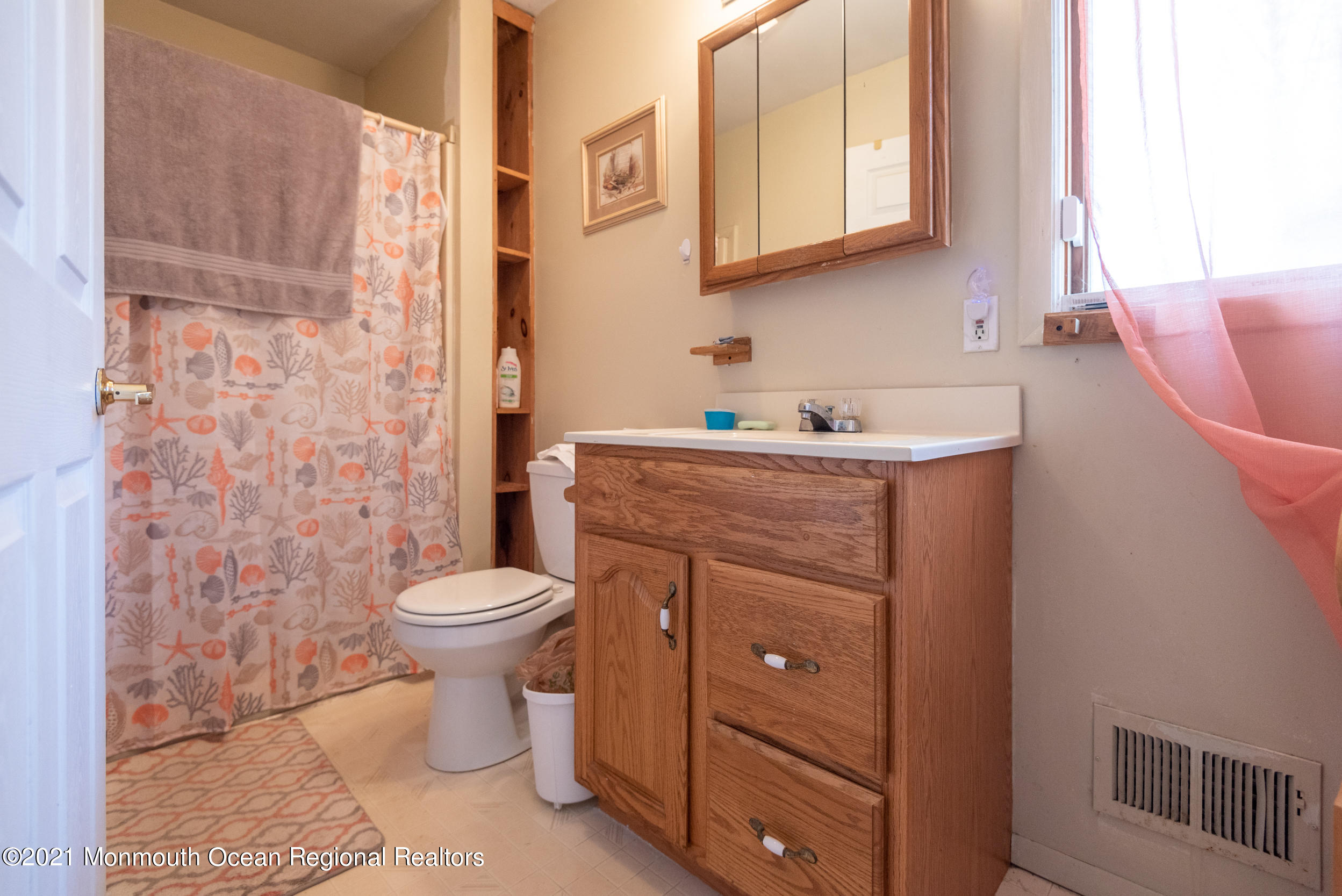 209 Pond Road Freehold, NJ 07728 - Photo 22 of 44 a bathroom with a granite countertop toilet sink and mirror