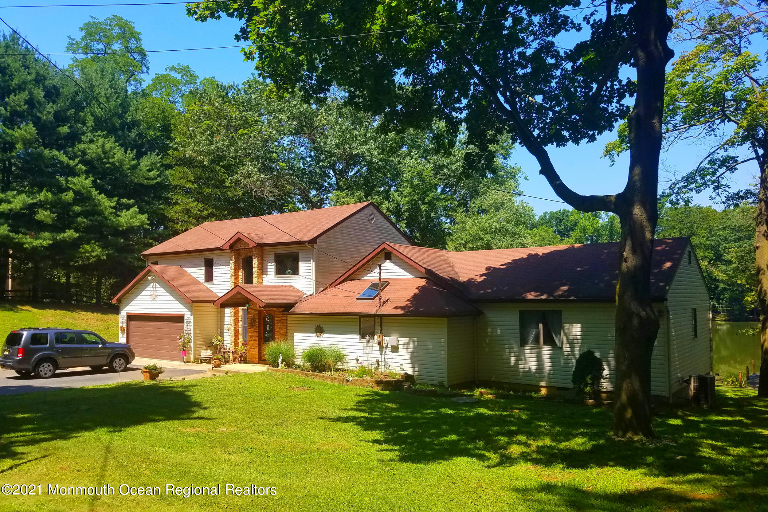 209 Pond Road Freehold, NJ 07728 - Photo 4 of 44 a view of a house with a yard porch and sitting area