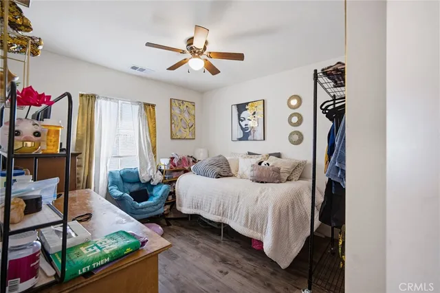 a bedroom with a bed a couch and a window