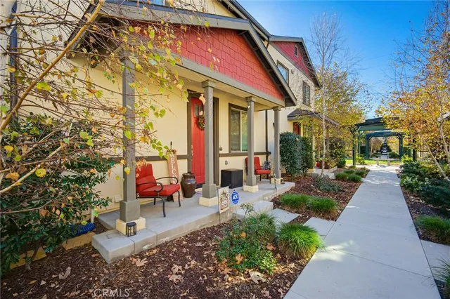 a view of a chair and tables in the patio in front of a house