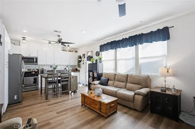 a living room with furniture and wooden floor