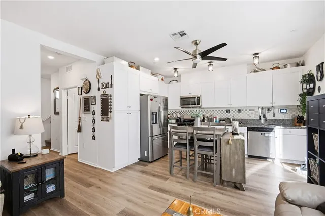 a view of a kitchen with dining table and chairs