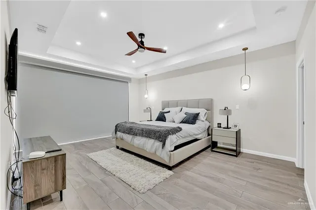 a living room with furniture and a ceiling fan