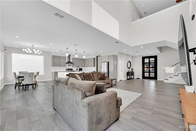 a living room with furniture and kitchen view