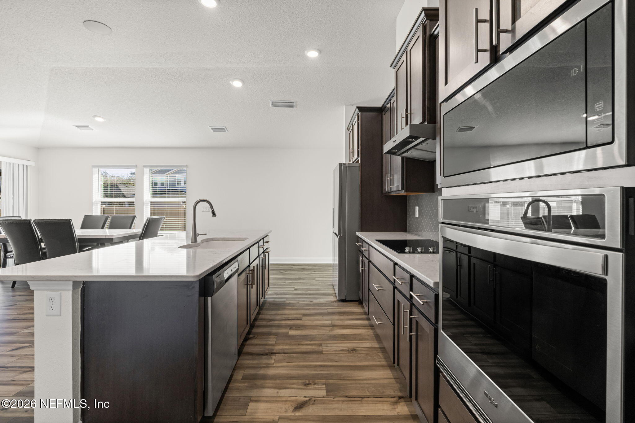 277 Rambling Brk Trail St. Johns, FL 32259 - Photo 8 of 51 a kitchen with stainless steel appliances granite countertop a sink and stove top oven