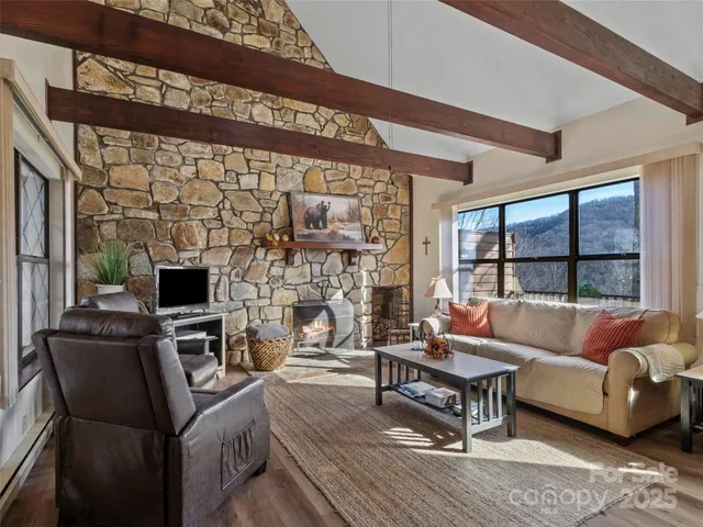 a living room with furniture a rug and a table