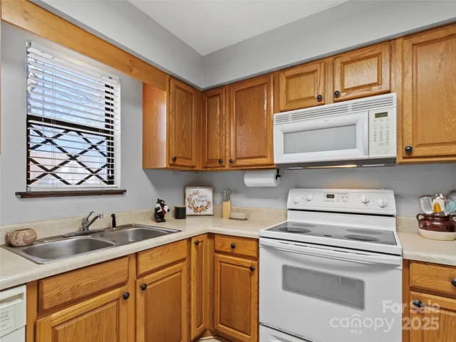 a kitchen with a sink cabinets and window