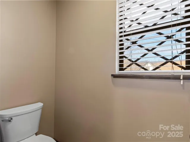 a bedroom with two beds and a large window