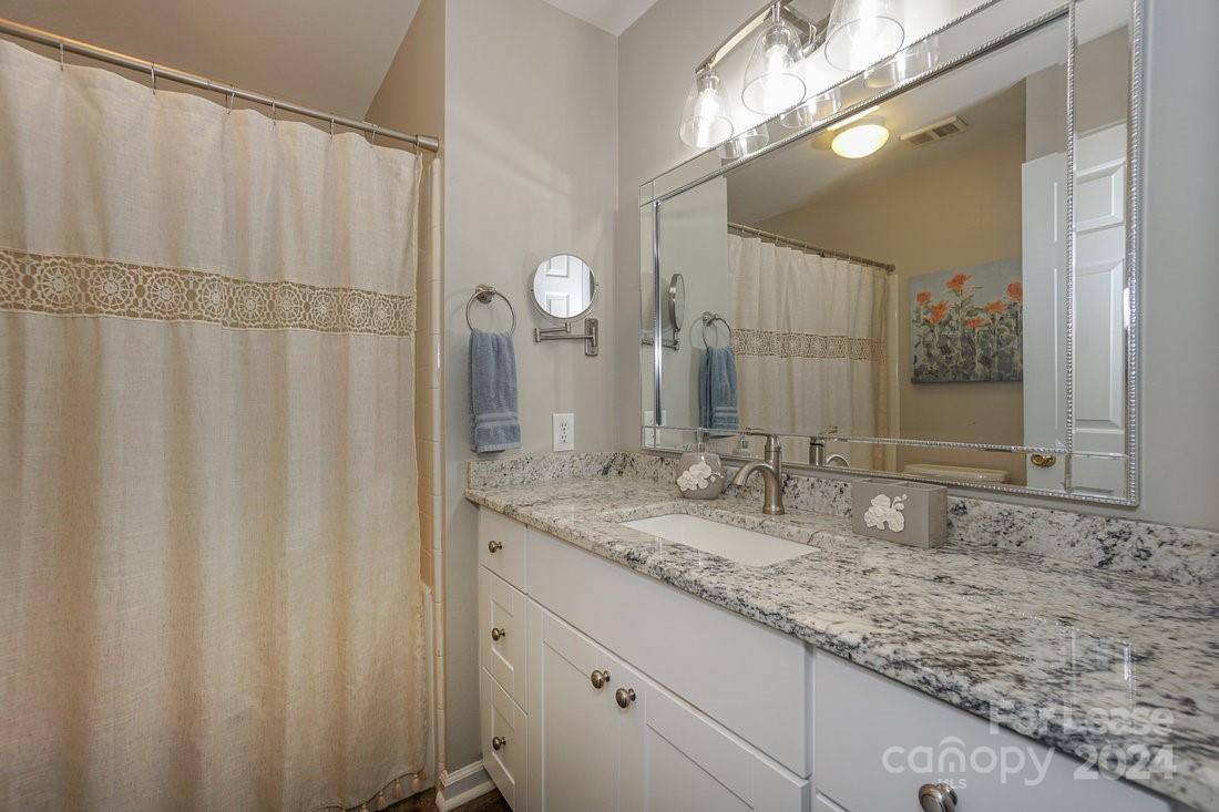 17542 Tuscany Lane Cornelius, NC 28031 - Photo 21 of 35 a bathroom with a granite countertop sink and a mirror