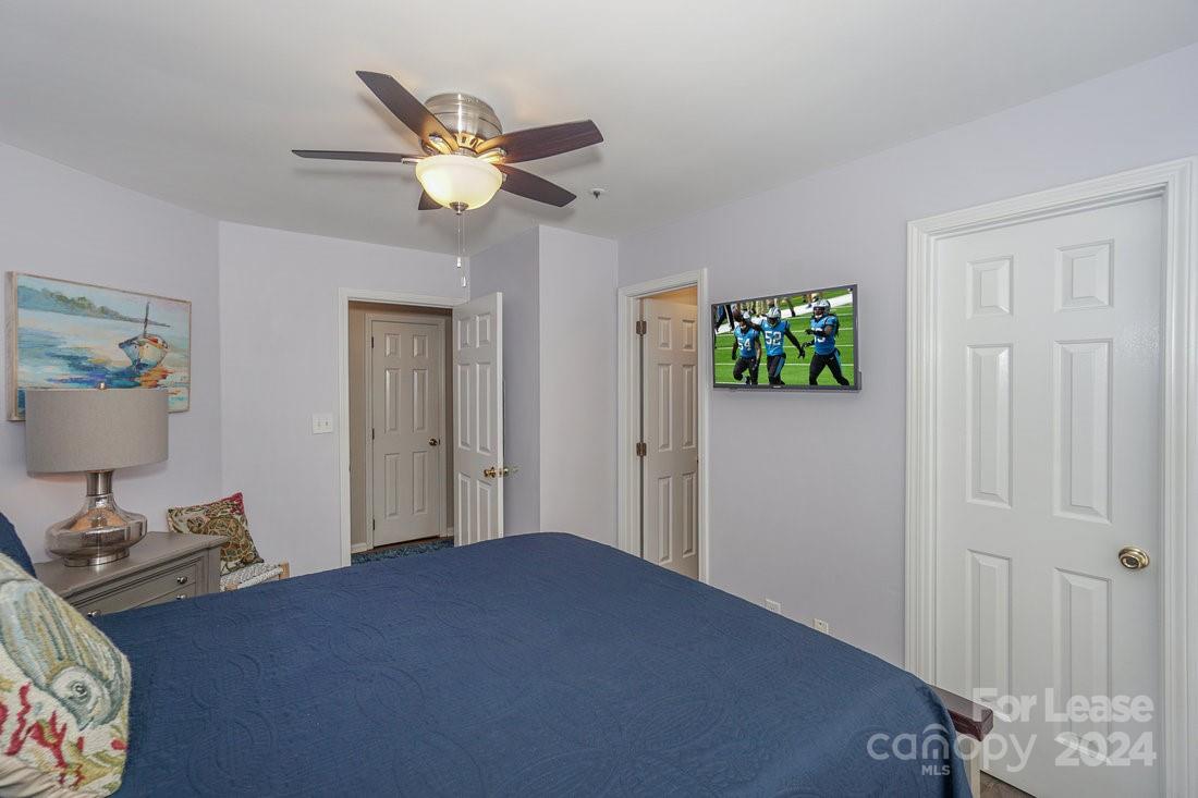 17542 Tuscany Lane Cornelius, NC 28031 - Photo 24 of 35 a bedroom with a bed and a chandelier