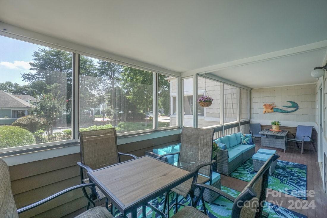 17542 Tuscany Lane Cornelius, NC 28031 - Photo 29 of 35 a living room with furniture a table and a large window