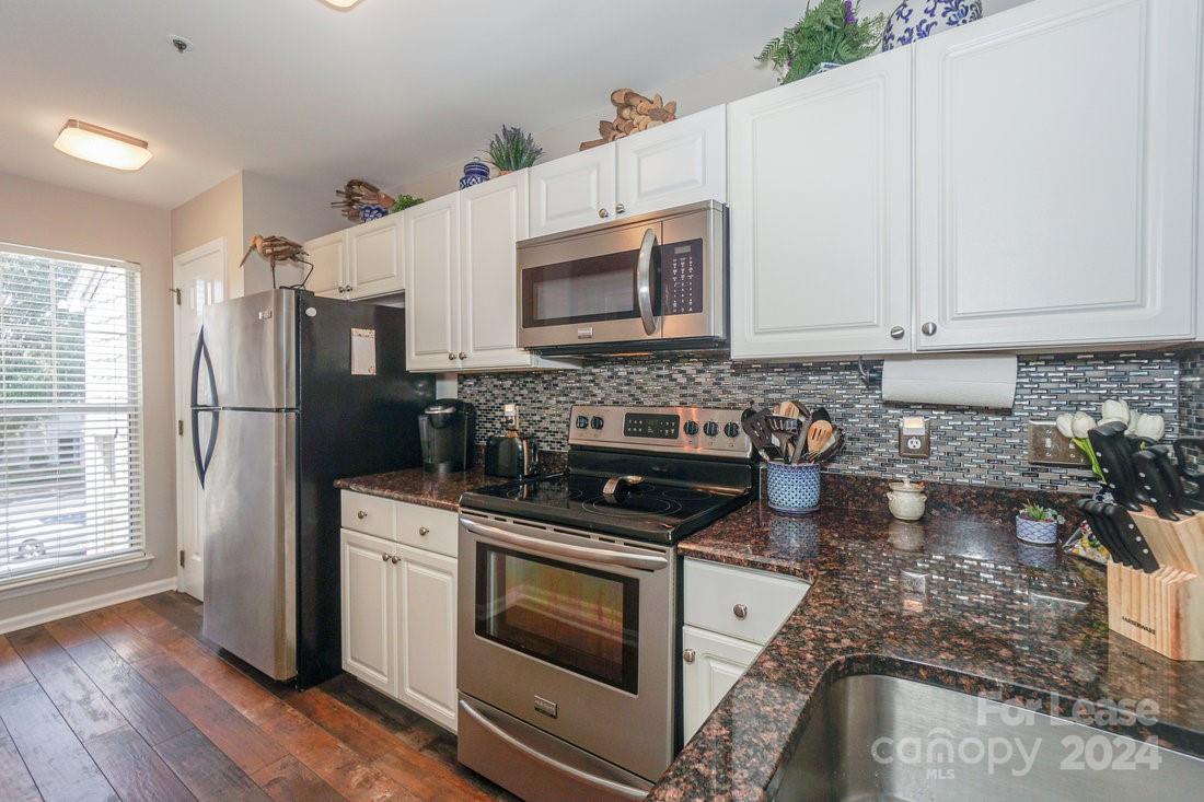 17542 Tuscany Lane Cornelius, NC 28031 - Photo 6 of 35 a kitchen with a stove a sink and a refrigerator