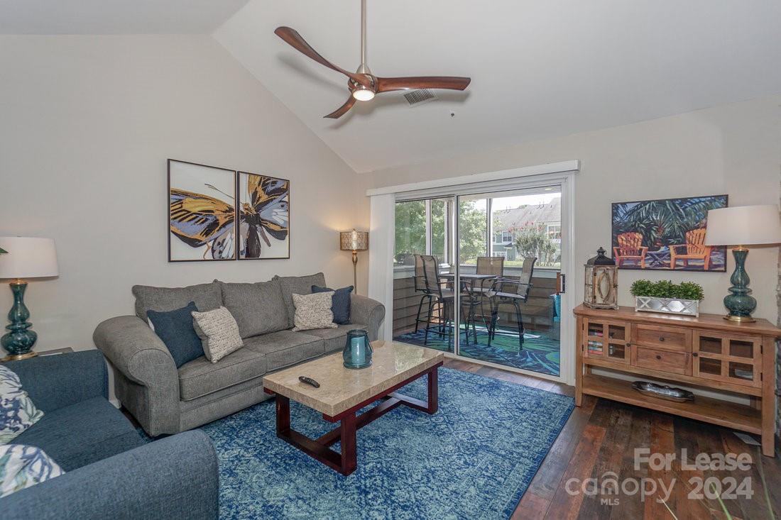 17542 Tuscany Lane Cornelius, NC 28031 - Photo 10 of 35 a living room with furniture a rug and a flat screen tv