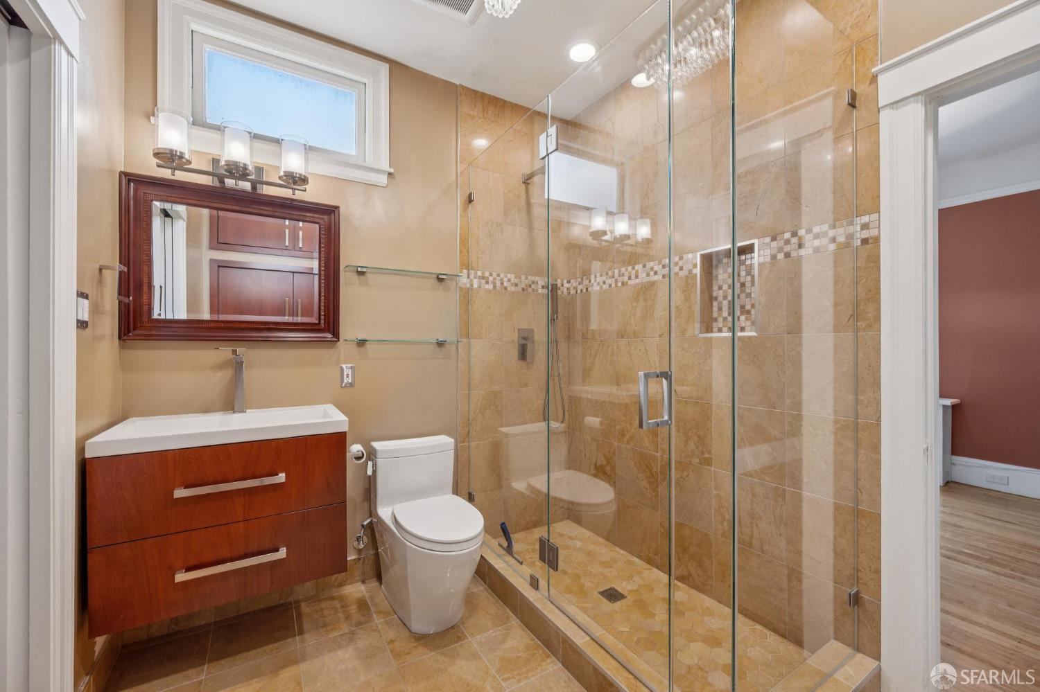 189 Commonwealth Avenue, Unit 3 San Francisco, CA 94118 - Photo 14 of 25 a bathroom with a toilet a sink shower and mirror