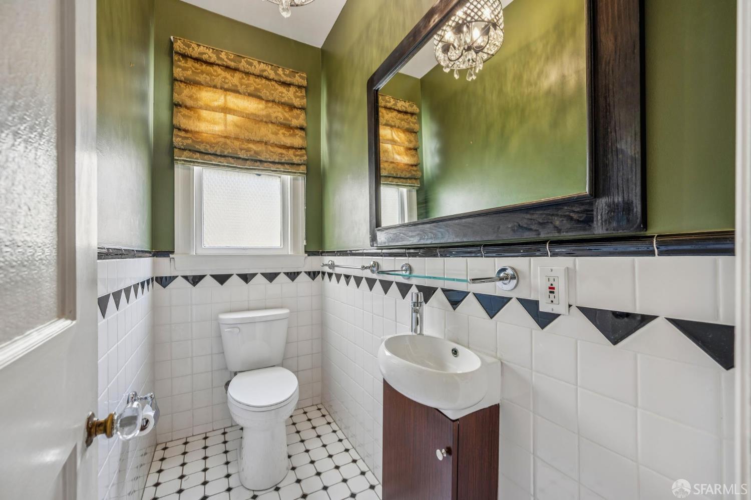 189 Commonwealth Avenue, Unit 3 San Francisco, CA 94118 - Photo 23 of 25 a bathroom with a sink a toilet and a mirror