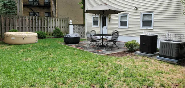 a view of backyard of house with seating space