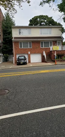 a view of building with car parked