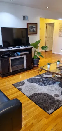 a view of an empty room with a flat screen tv and outdoor space