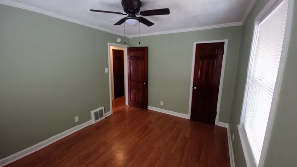wooden floor in an empty room with a window