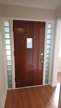 an empty room with windows cabinet and door