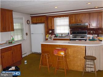 99 Warden Road Doylestown, PA 18901 - Photo 5 of 11 a kitchen with stainless steel appliances a refrigerator and a stove top oven
