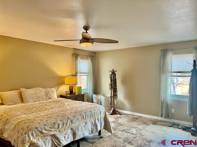 2010 Rolling Road Cortez, CO 81321 - Photo 7 of 21 a bedroom with a bed and a chandelier