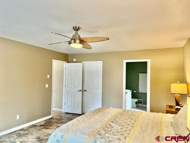 2010 Rolling Road Cortez, CO 81321 - Photo 8 of 21 a bedroom with a bed and a chandelier