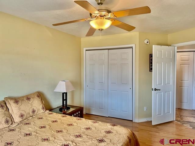 2010 Rolling Road Cortez, CO 81321 - Photo 10 of 21 a bedroom with a bed and a chandelier