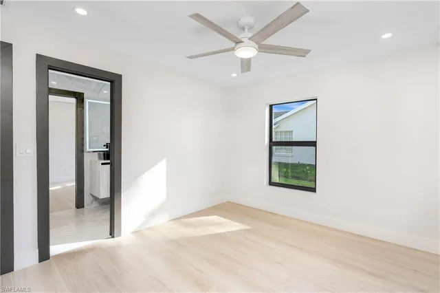 an empty room with a bathroom and a window