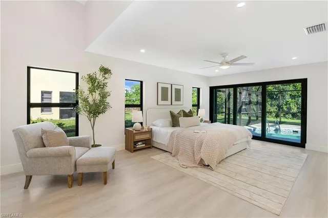 a spacious bedroom with a large bed and a large window