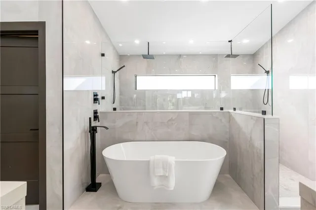 a bathroom with a bathtub and shower