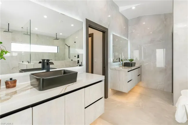 a kitchen with kitchen island a sink appliances and cabinets