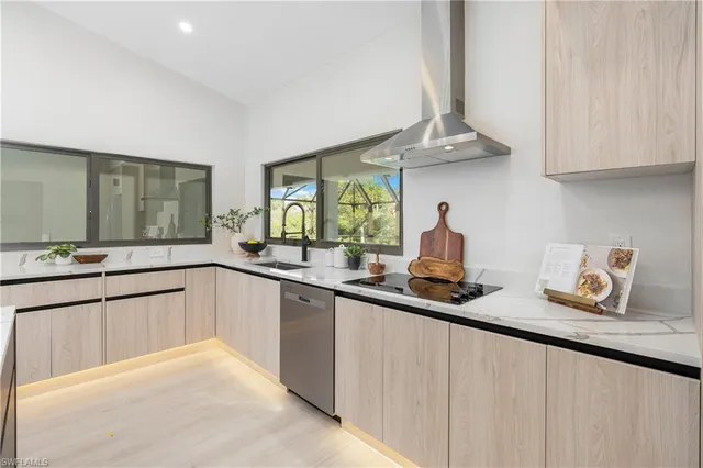 a kitchen with granite countertop a sink stainless steel appliances and cabinets