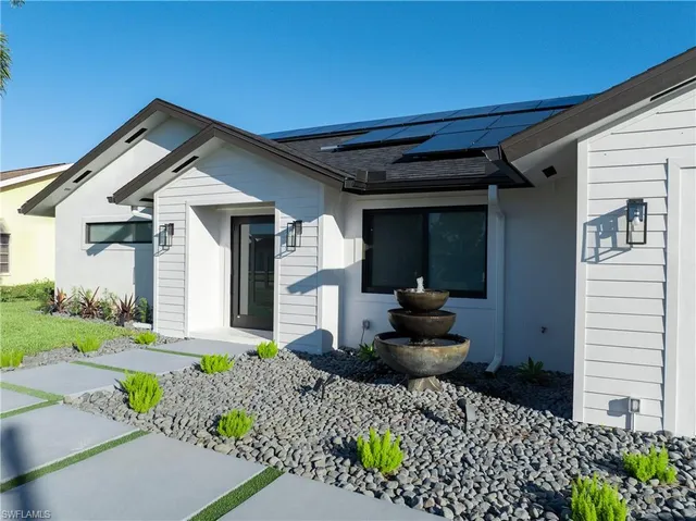 a front view of a house with garden