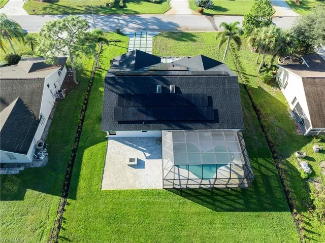 an aerial view of a house with a yard