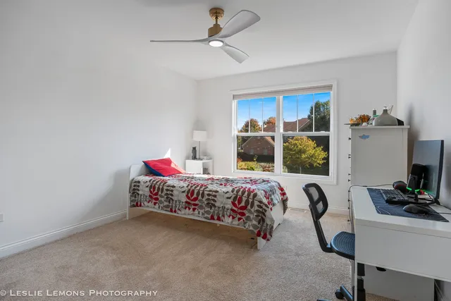 a bedroom with a bed and a desk