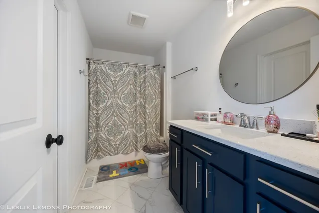 a bathroom with a sink double vanity and a mirror