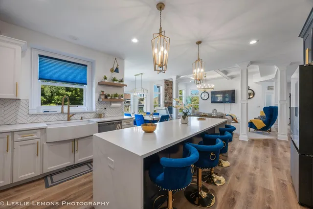 a kitchen with stainless steel appliances kitchen island granite countertop a sink a center island and cabinets
