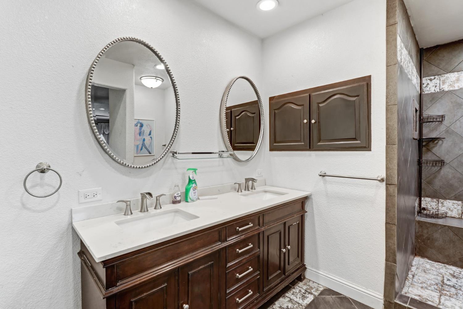 4330 Cavitt Stallman Road Granite Bay, CA 95746 - Photo 25 of 85 a bathroom with a double vanity sink and a mirror