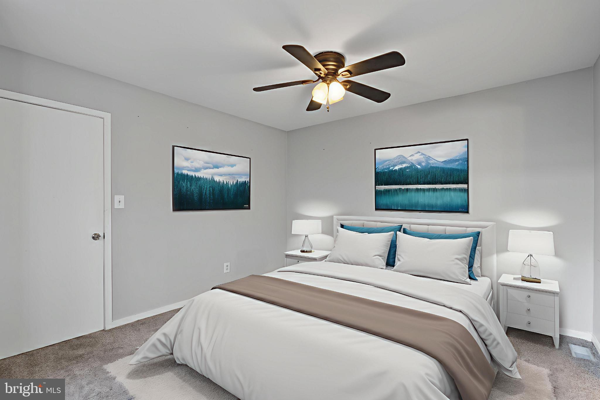 9802 Sailfish Terrace Gaithersburg, MD 20886 - Photo 9 of 18 a bedroom with a large bed and a chandelier