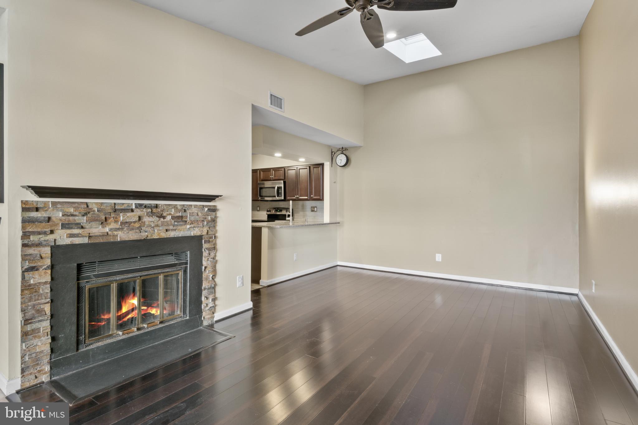 9802 Sailfish Terrace Gaithersburg, MD 20886 - Photo 6 of 18 a living room with wooden floor and a fireplace