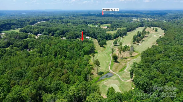 an aerial view of a house with lots of trees