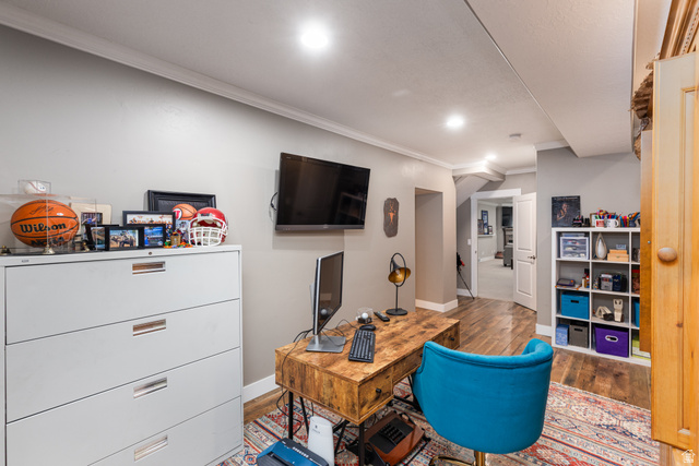 1132 Sunset Dunes Way Draper, UT 84020 - Photo 14 of 35 Dedicated workspace featuring a wood-finish desk, wall-mounted television, recessed lighting, crown molding, and wood-finish flooring