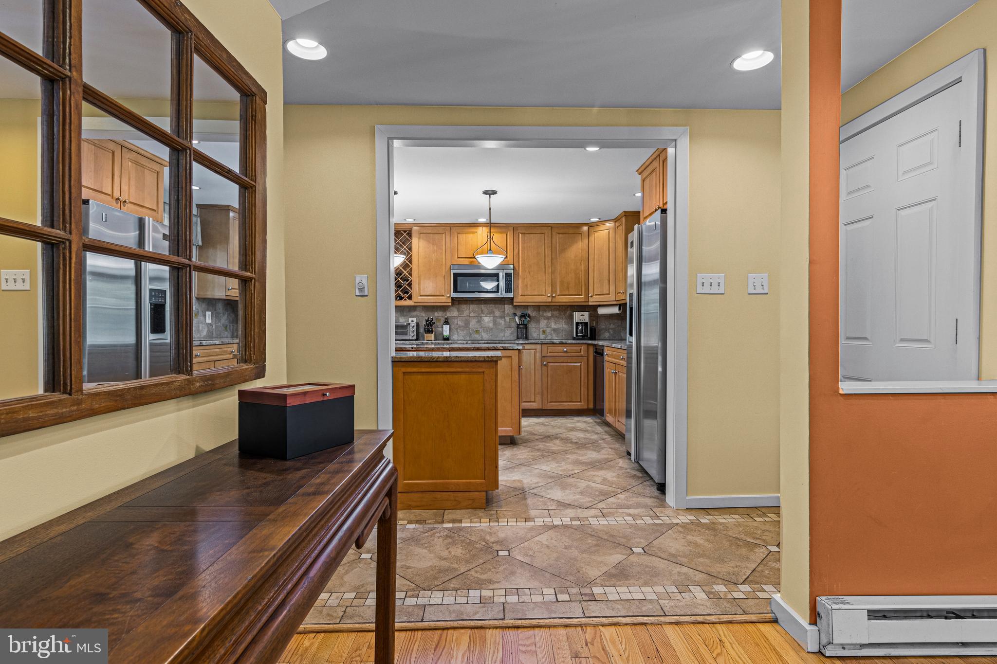 231 West Valley Road Wayne, PA 19087 - Photo 26 of 61 a kitchen with stainless steel appliances kitchen island granite countertop a refrigerator and a stove