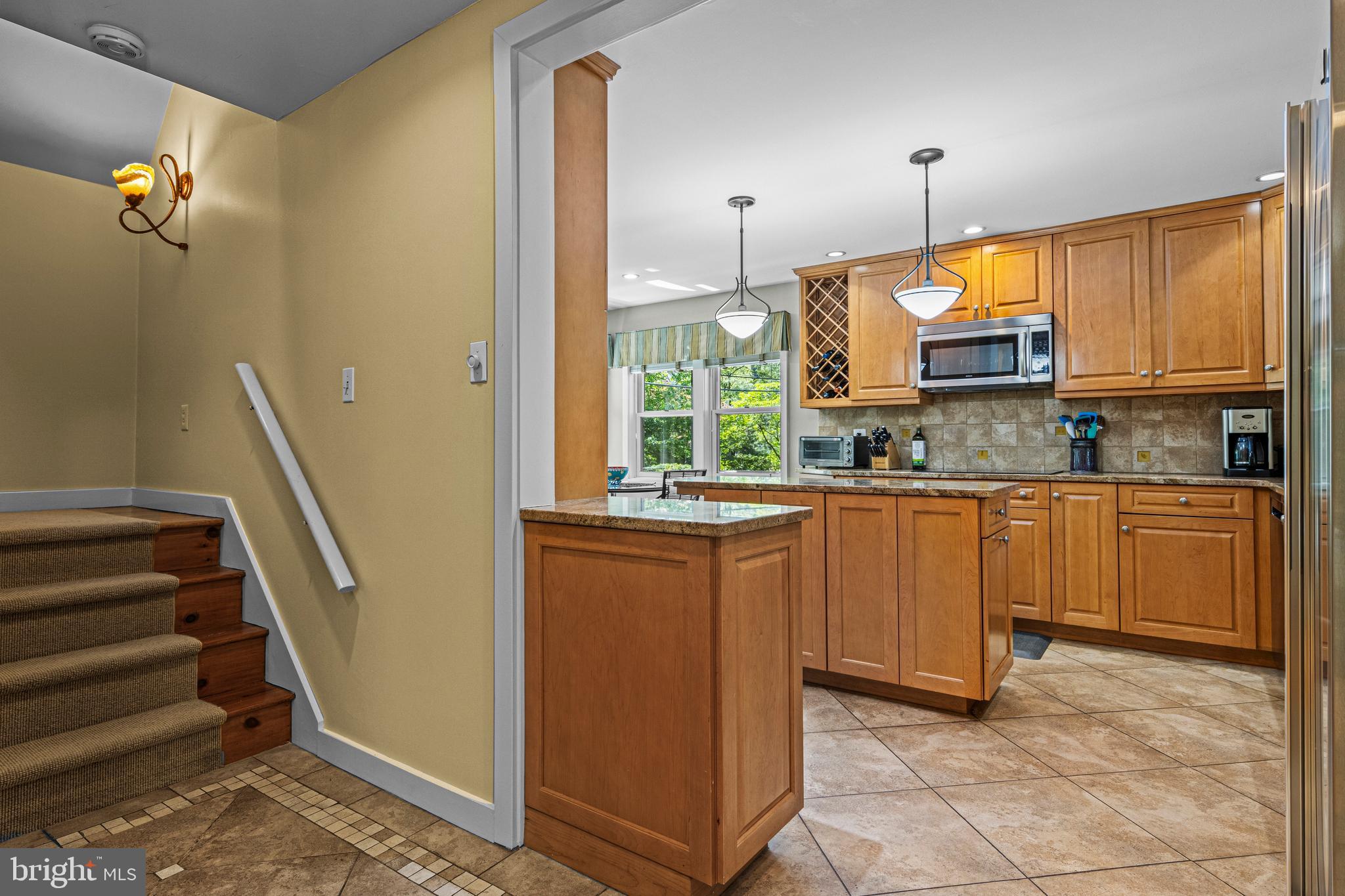 231 West Valley Road Wayne, PA 19087 - Photo 27 of 61 a kitchen with granite countertop a stove a sink and a window