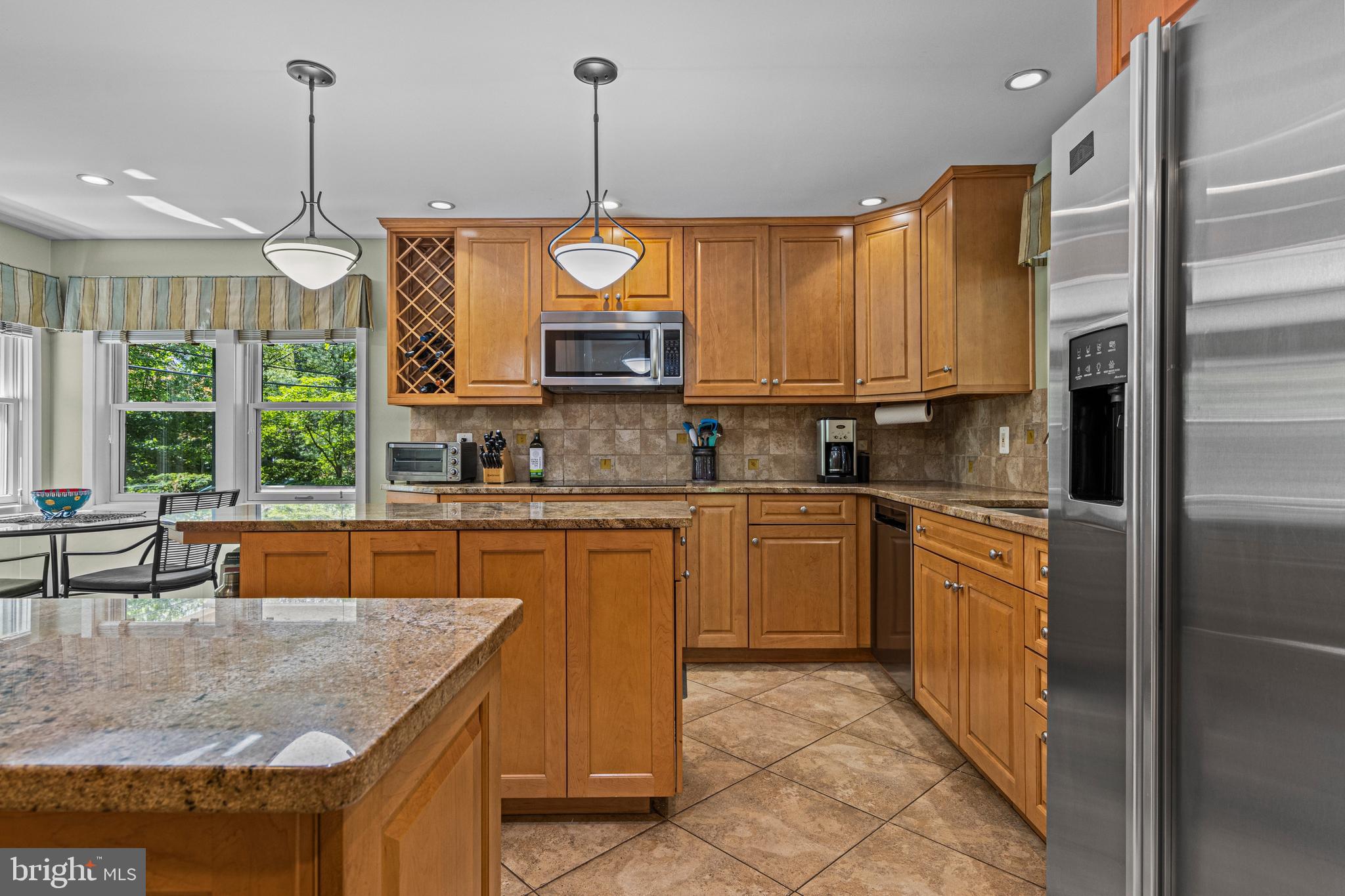 231 West Valley Road Wayne, PA 19087 - Photo 28 of 61 a kitchen with stainless steel appliances granite countertop a sink a stove and a wooden floors