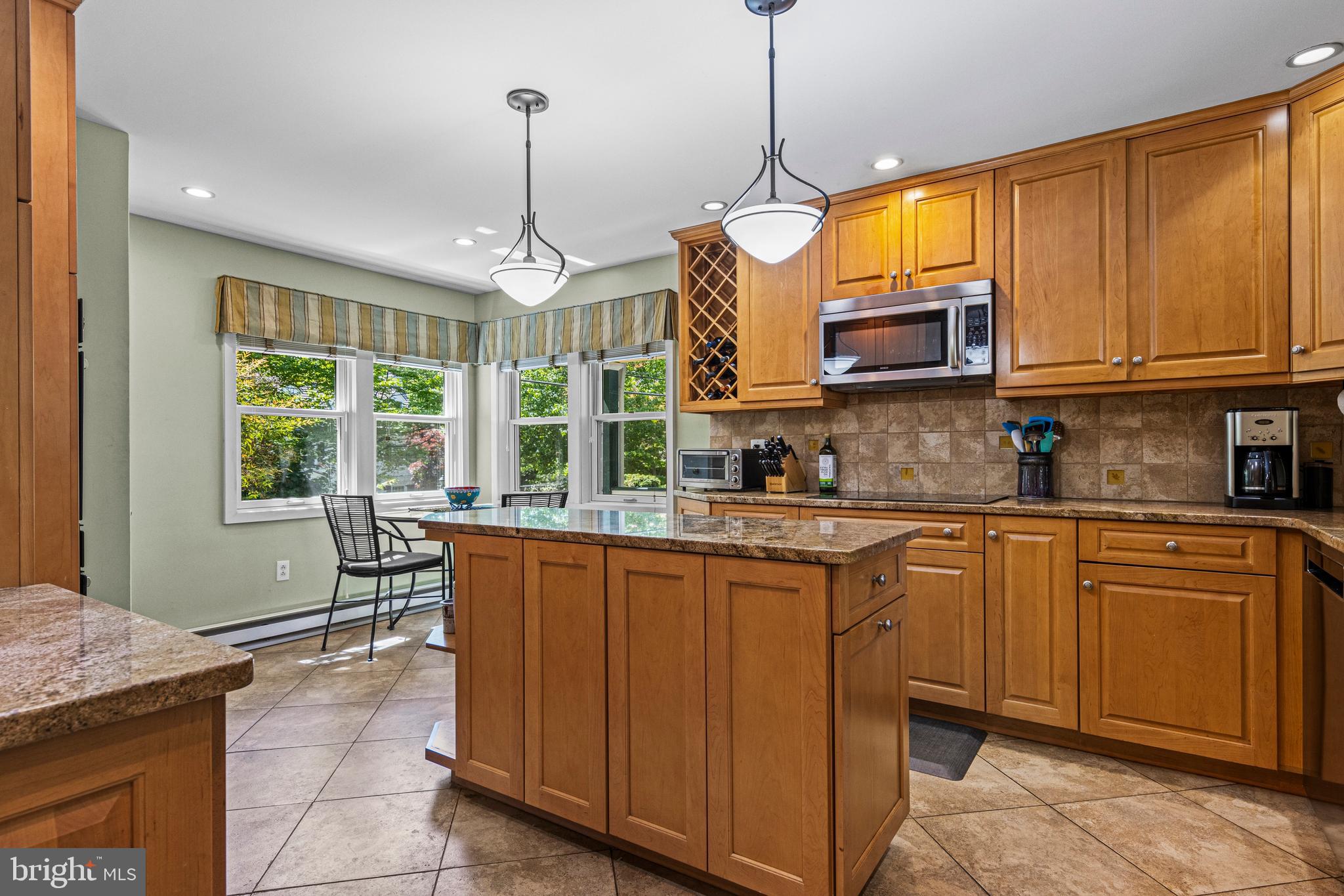 231 West Valley Road Wayne, PA 19087 - Photo 29 of 61 a kitchen with stainless steel appliances granite countertop wooden cabinets a window and a sink