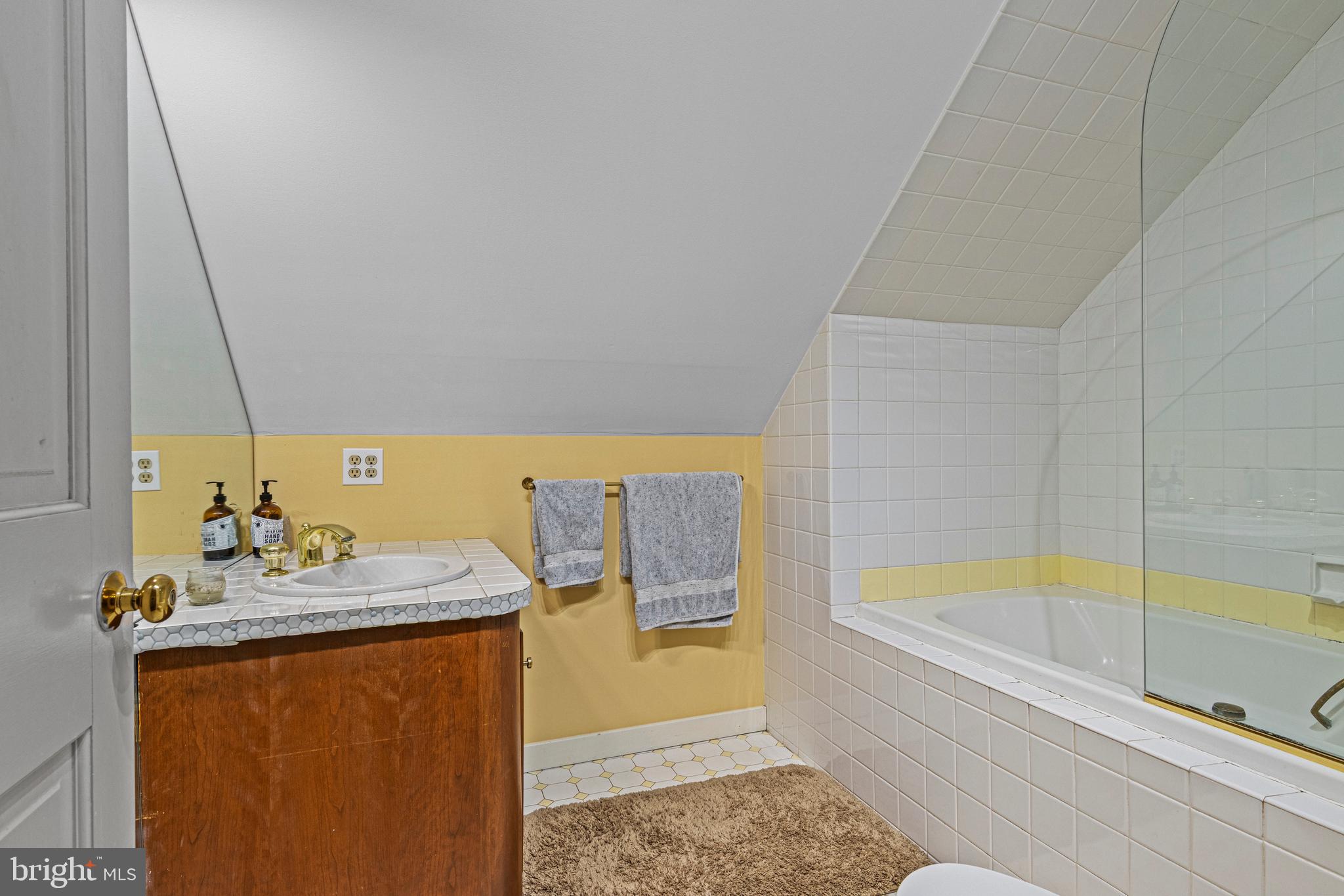 231 West Valley Road Wayne, PA 19087 - Photo 40 of 61 a bathroom with a bathtub sink and mirror